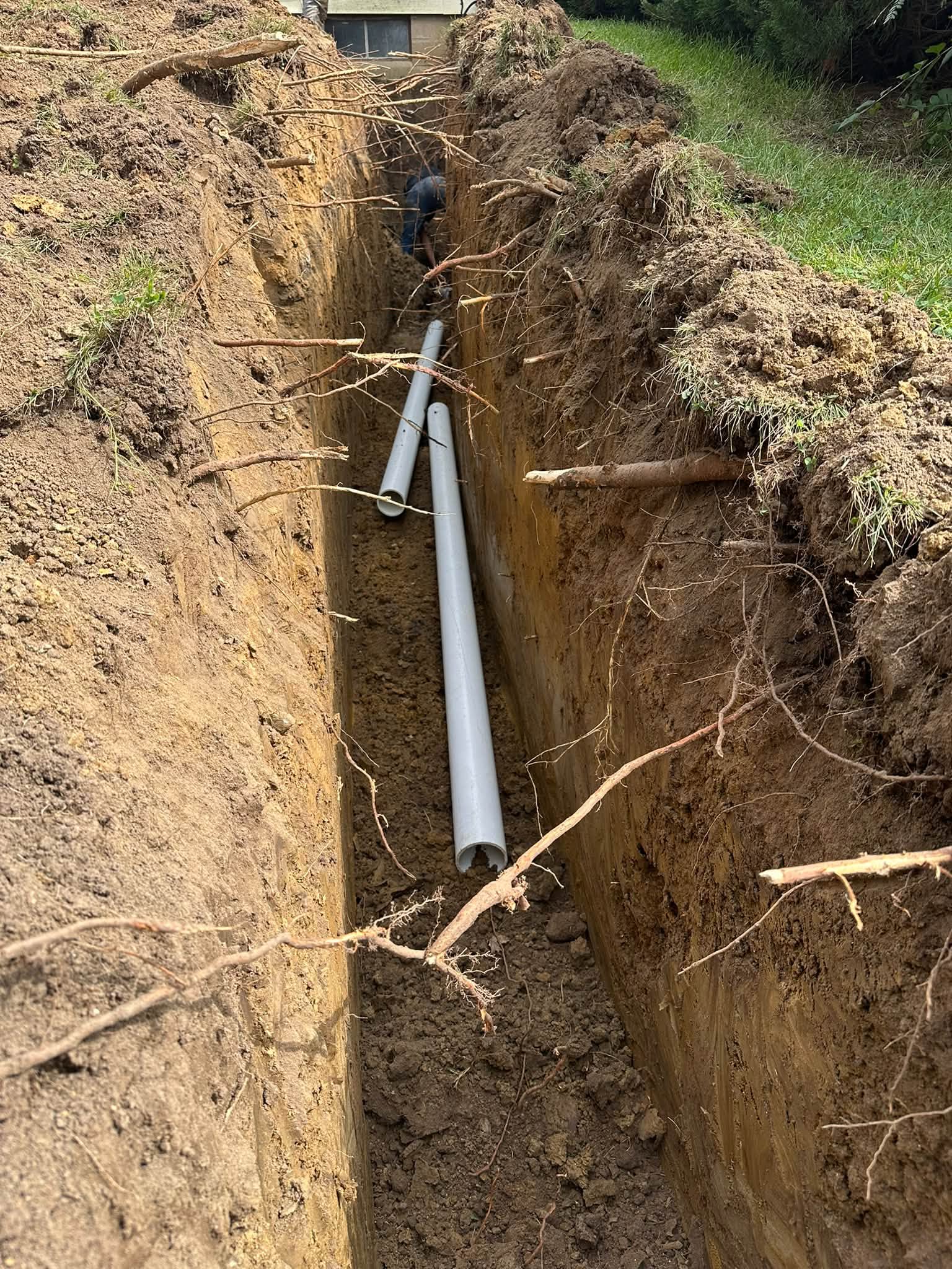 New sewer pipe laid in an open trench in Swisher, Iowa