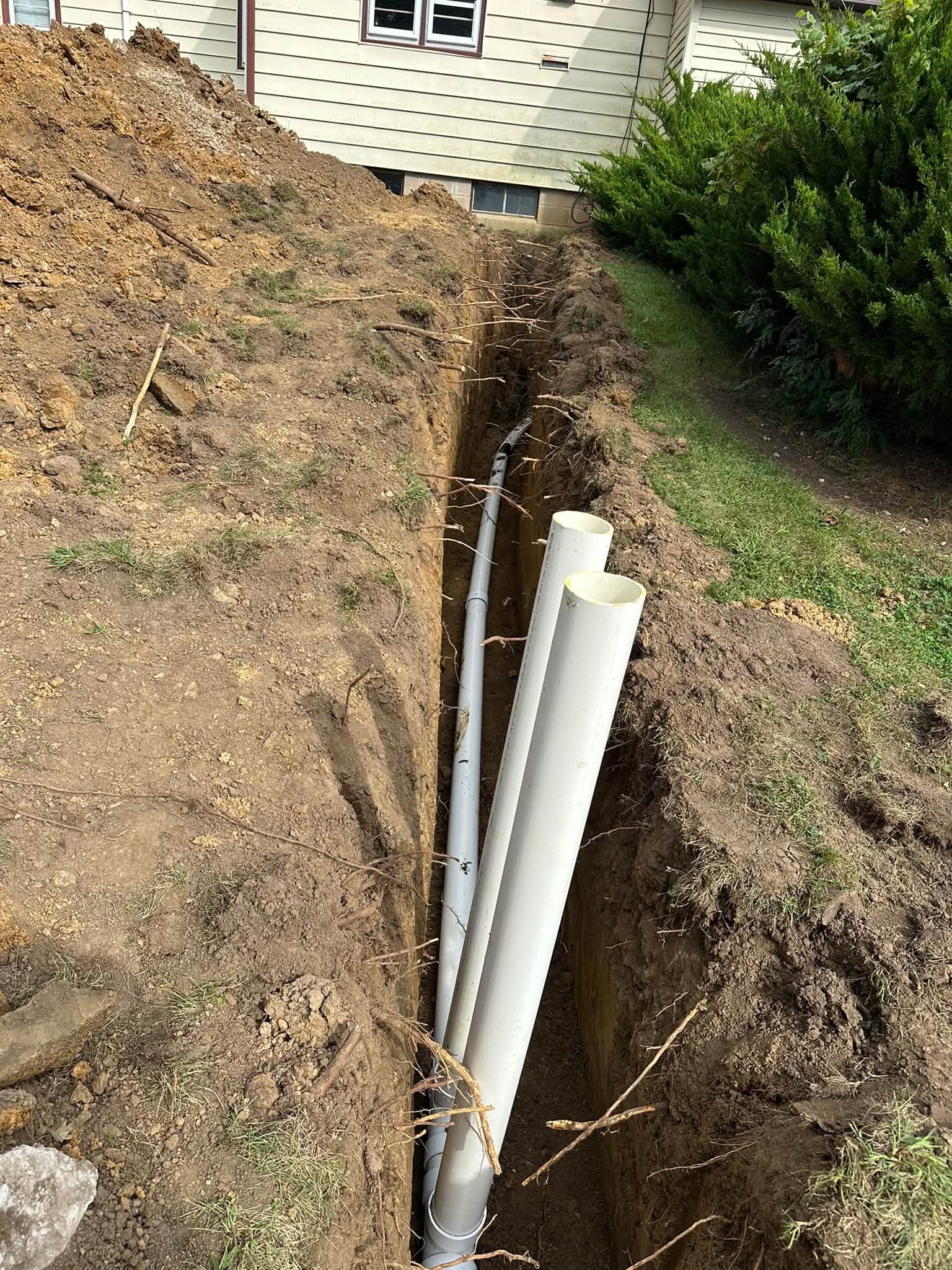 Sewer pipe fitted and graded before backfill in Swisher, Iowa