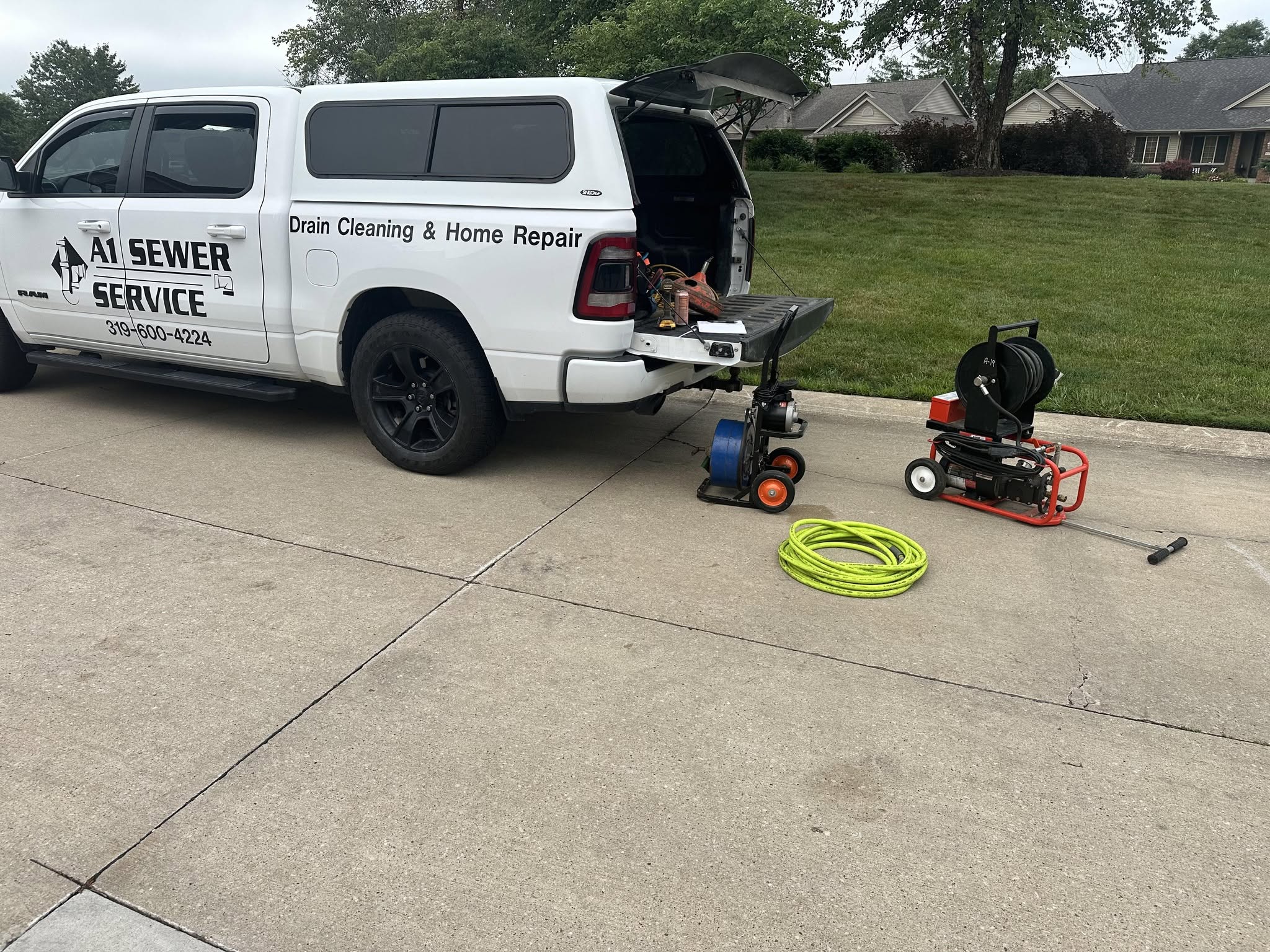 A1 Sewer Service truck with jetter and drain machine staged on site