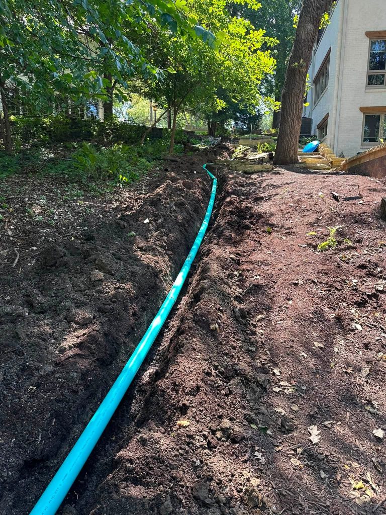 Downspout drain line project near a city park