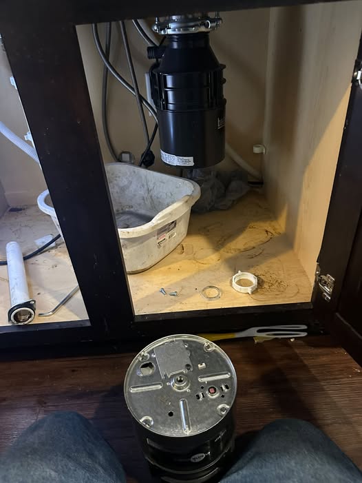 Garbage disposal replacement under a kitchen sink in Iowa City