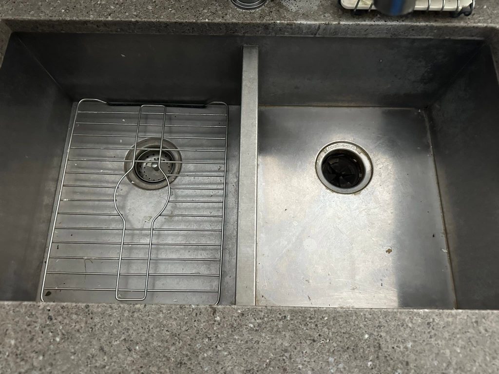 Before: worn double-bowl undermount sink