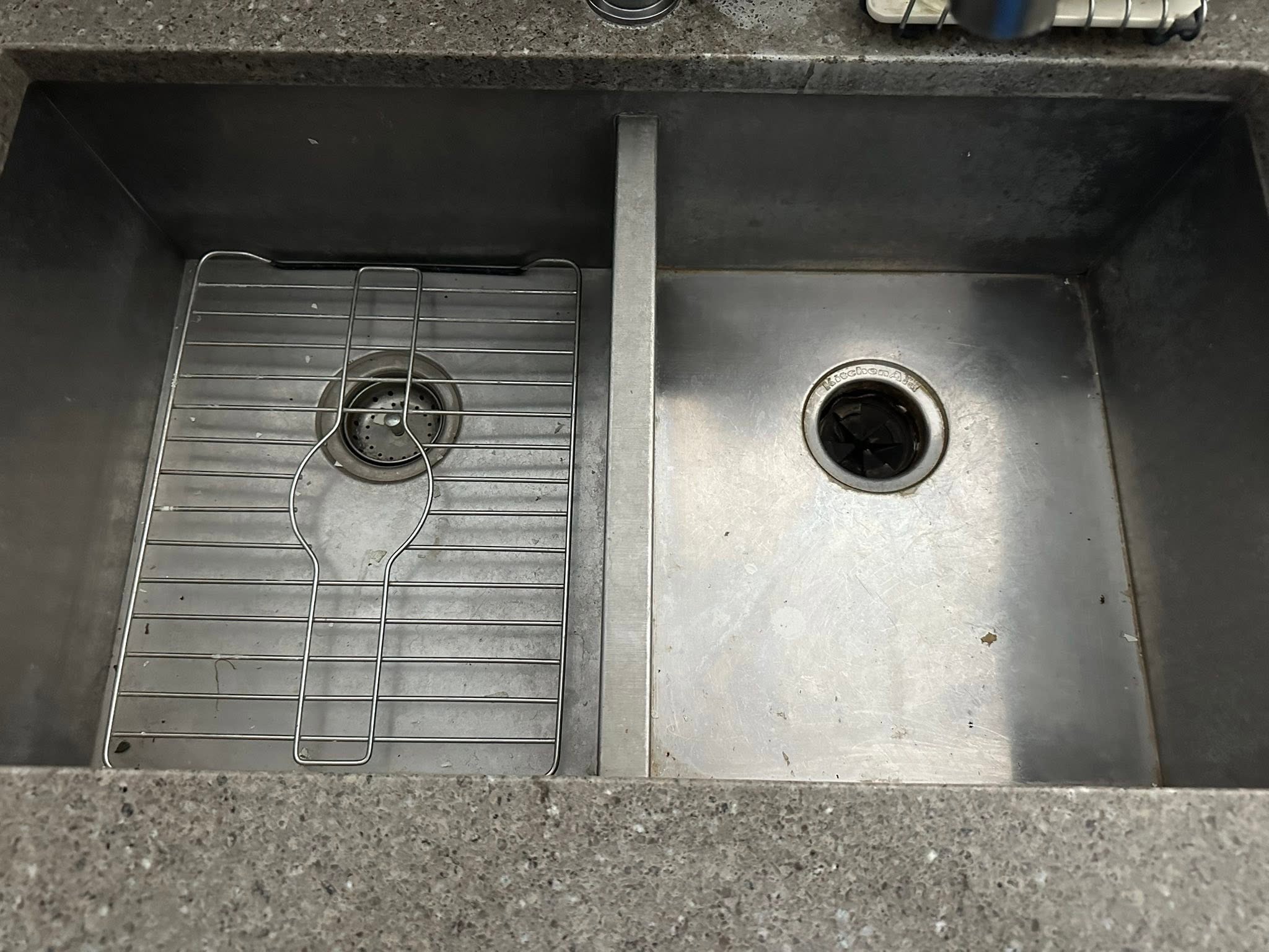 Old worn double bowl kitchen sink before replacement