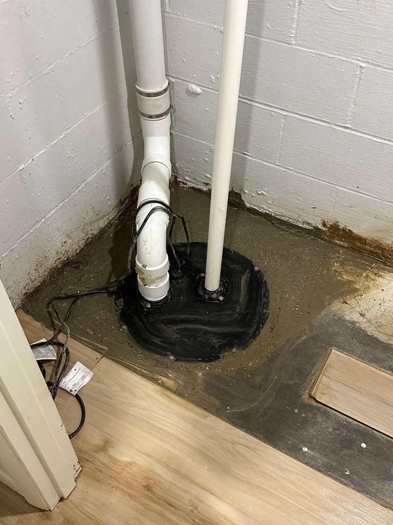 New sump pump pit with a new pump and discharge line outside